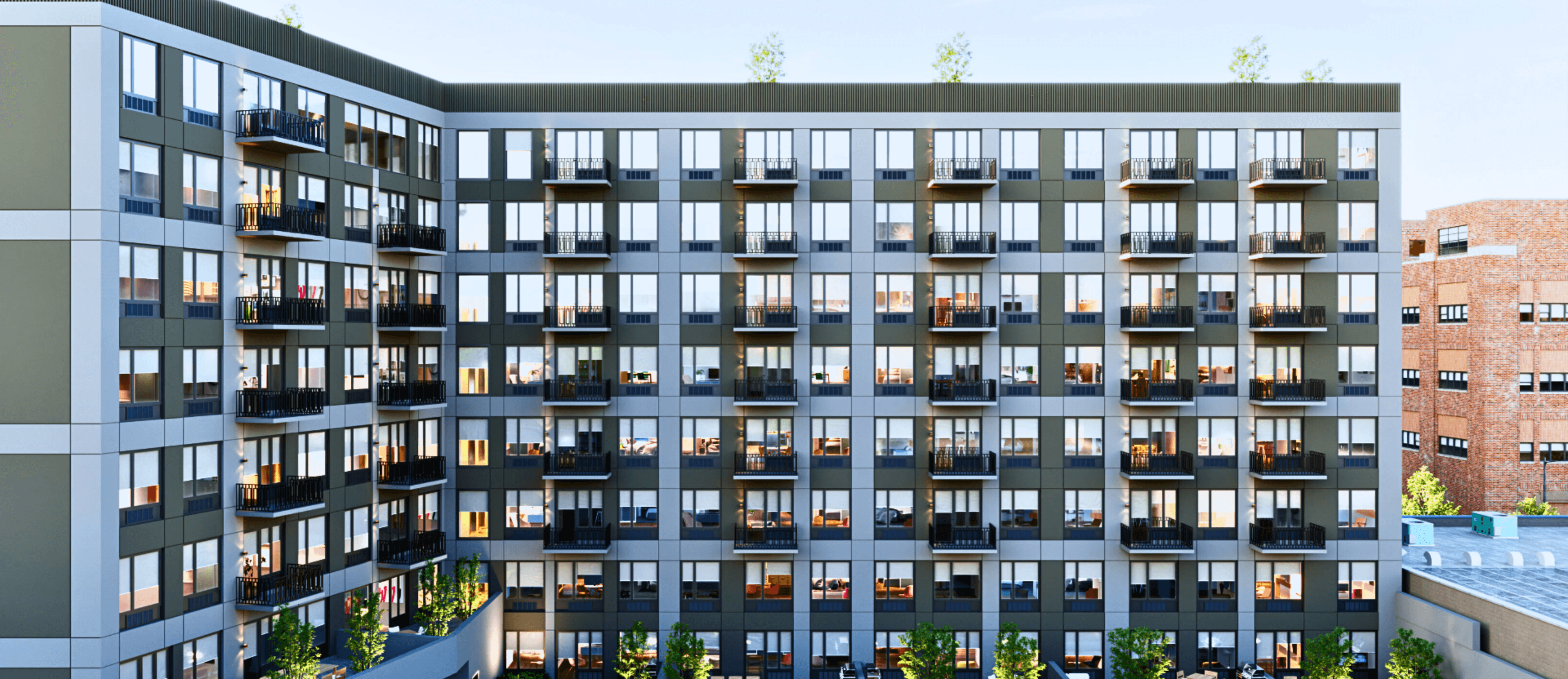 La fachada completa de ladrillo con balcones de The Astelle a lo largo de Rider Avenue en Mott Haven